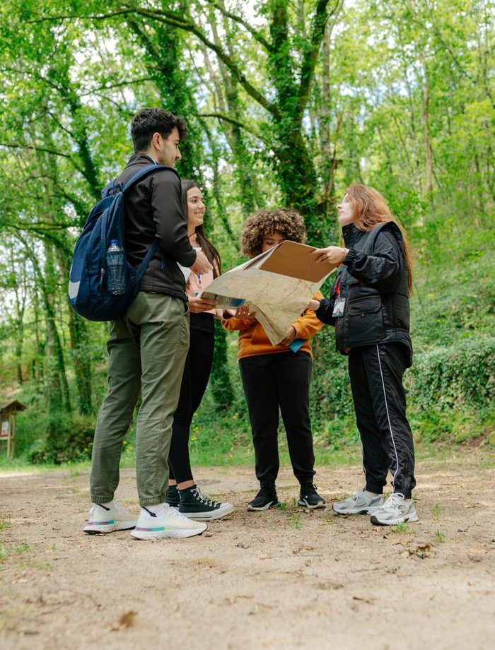 A local guide leading a small group through a forest trail
