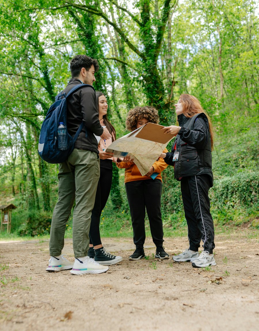A local guide leading a small group through a forest trail